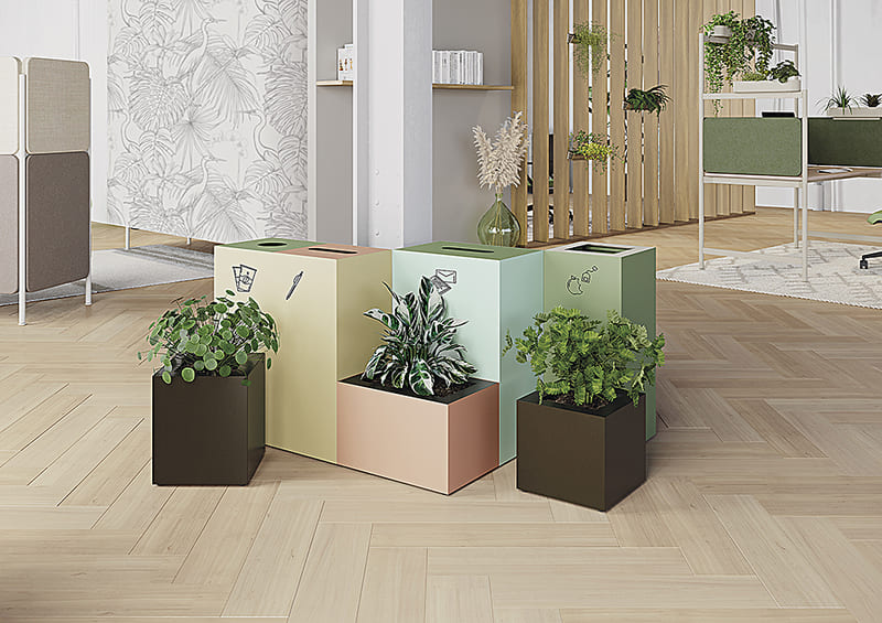 Modules de tri PICK'UP en configuration colorée, associés à des plantes pour une ambiance écoresponsable